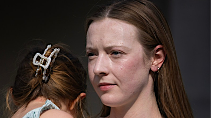 Another 16x9 thumbnail of the same photo, but zoomed in on the woman&rsquo;s face.